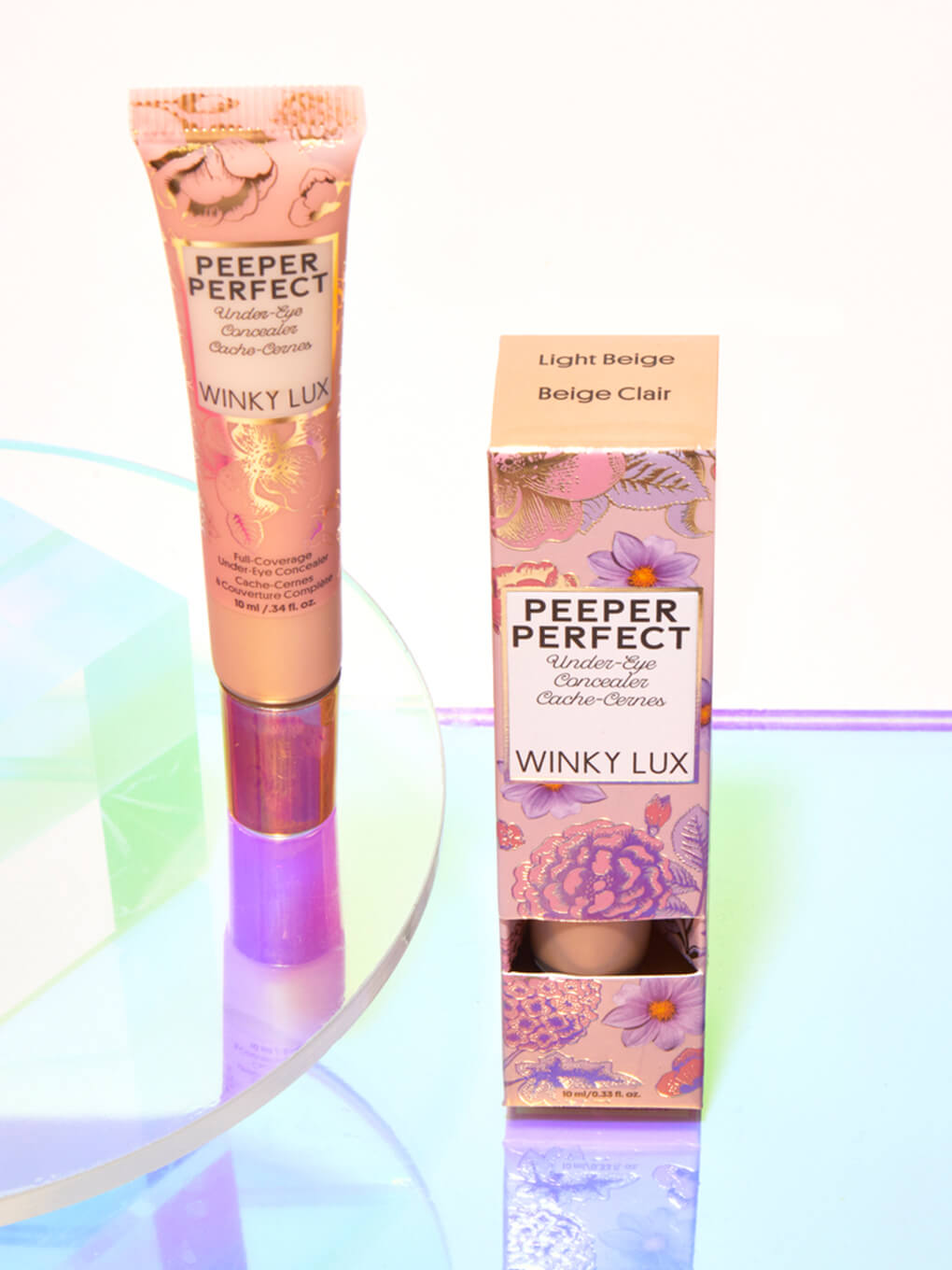 Light/Beige -- peeper perfect under eye concealer next to box with shiny props Light/Beige -- peeper perfect under eye concealer next to box with shiny props