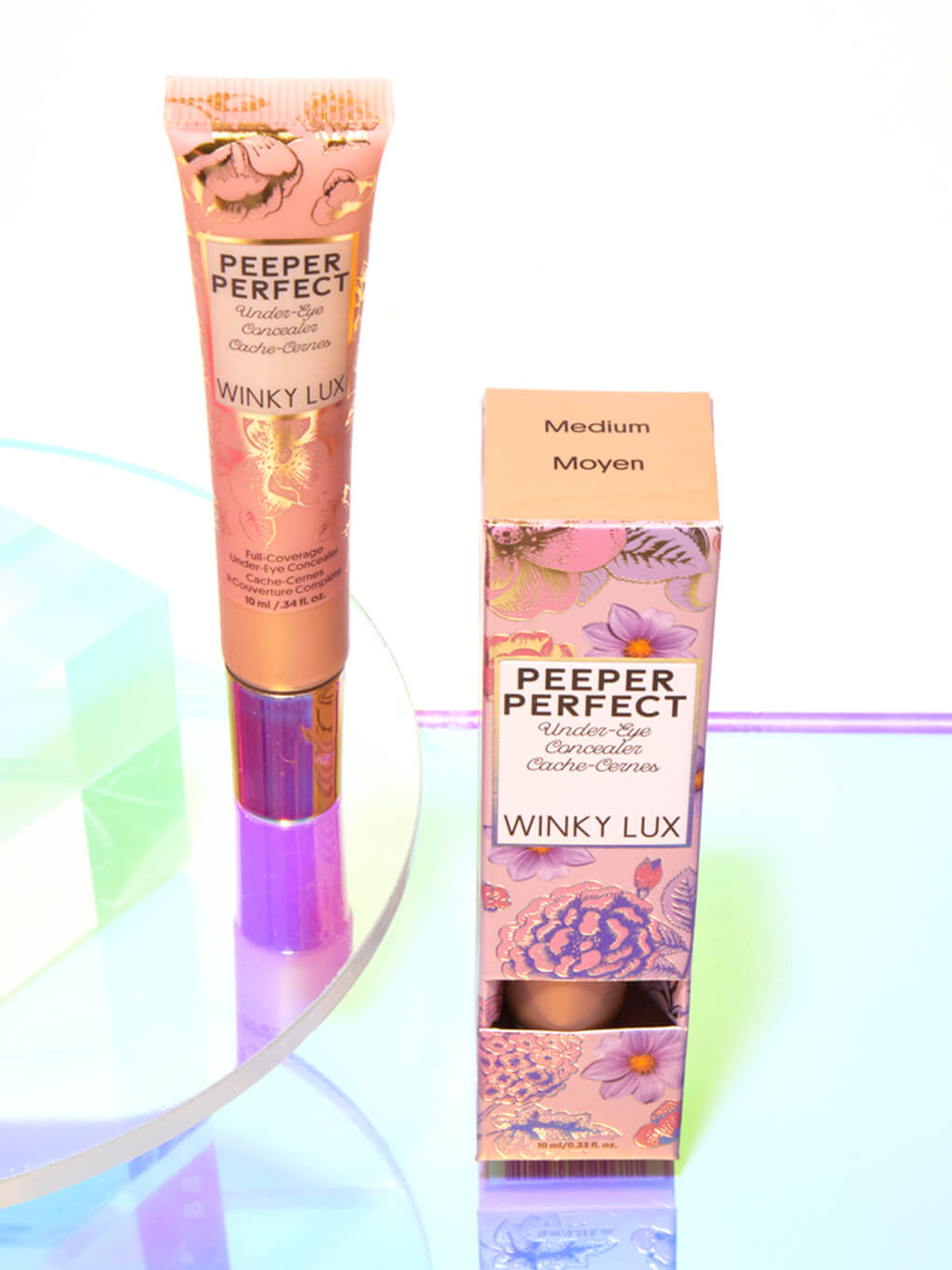 Medium -- peeper perfect under eye concealer next to box with shiny props Medium -- peeper perfect under eye concealer next to box with shiny props