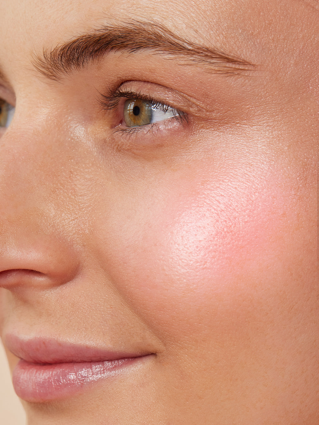 Pink Opal -- close up of model's cheek with liquid highlighter on for luminous glow