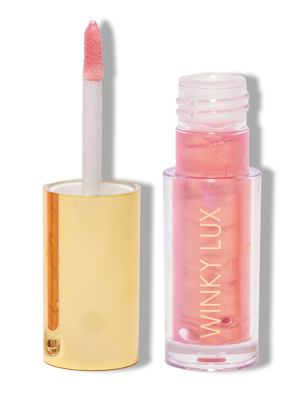 Pink opal shimmer -- nourishing golden pink lip oil with cap off on white background