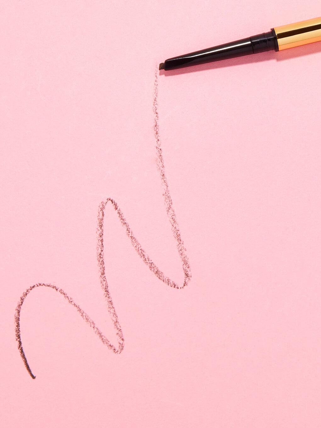 mini unibrow precision brow pencil drawing a line on pink background