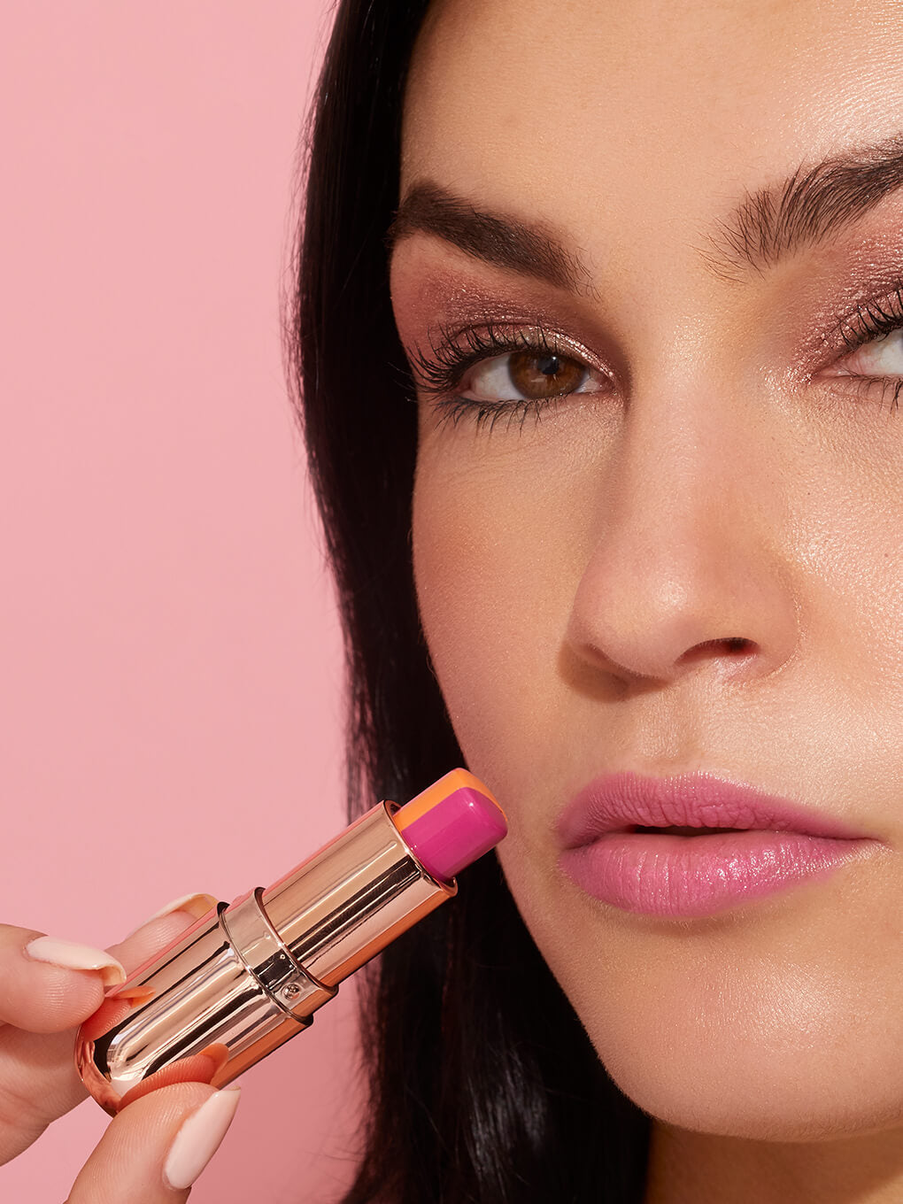 brunette model applying sorbet tinted lip balm