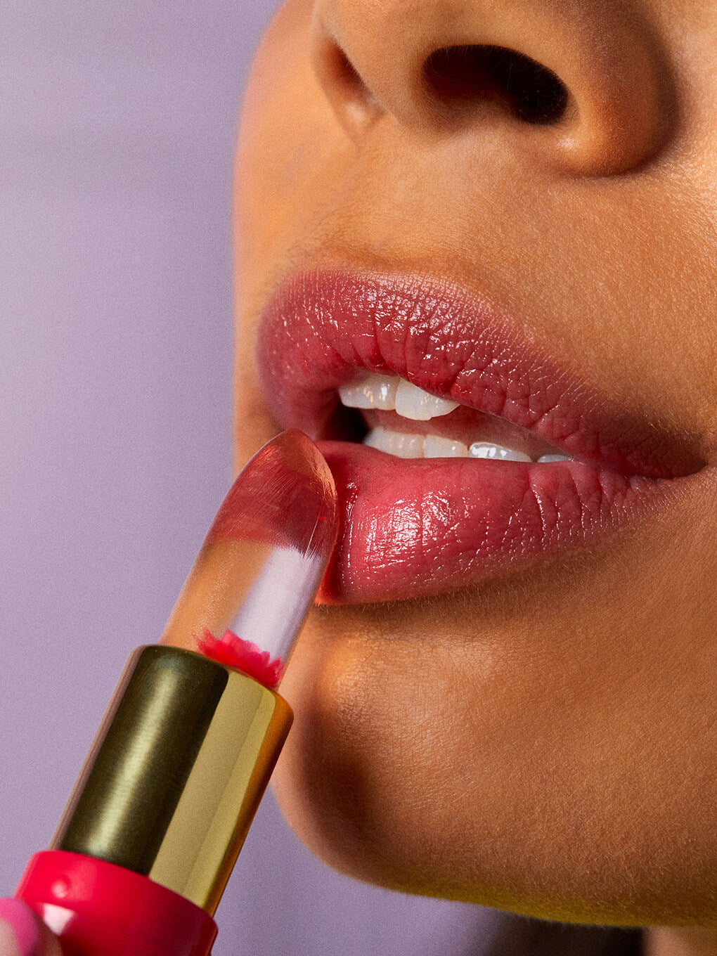 close up of brunette model applying flower pH lip balm