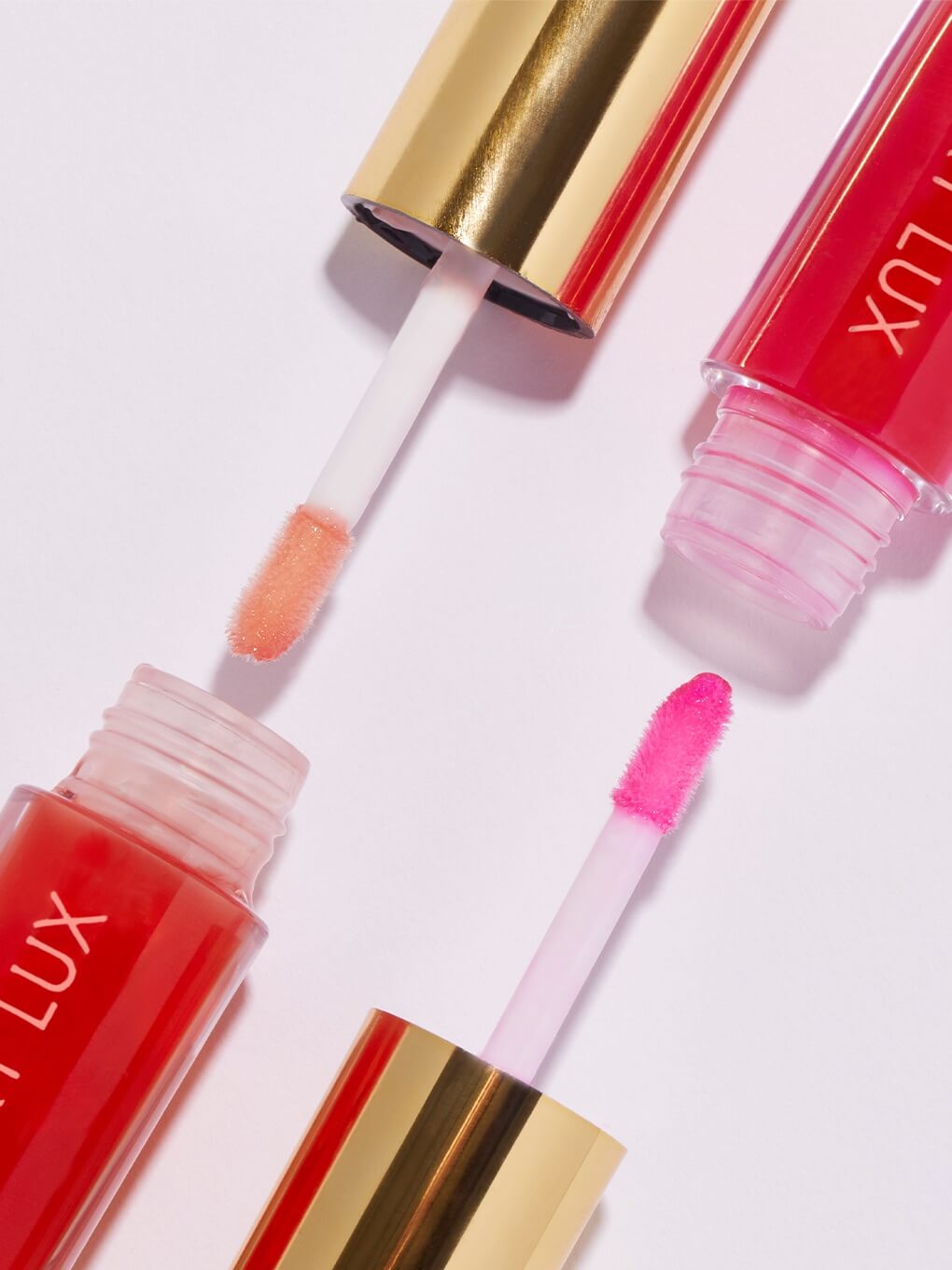 flat lay of barely there lip oils with applicator out of component