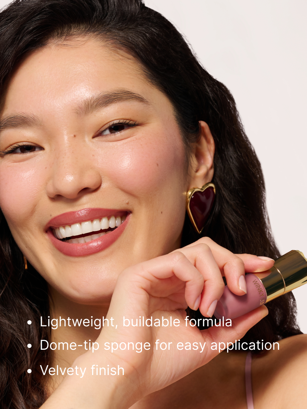 rose reverie  -- cheeky rose liquid blush with cap on model