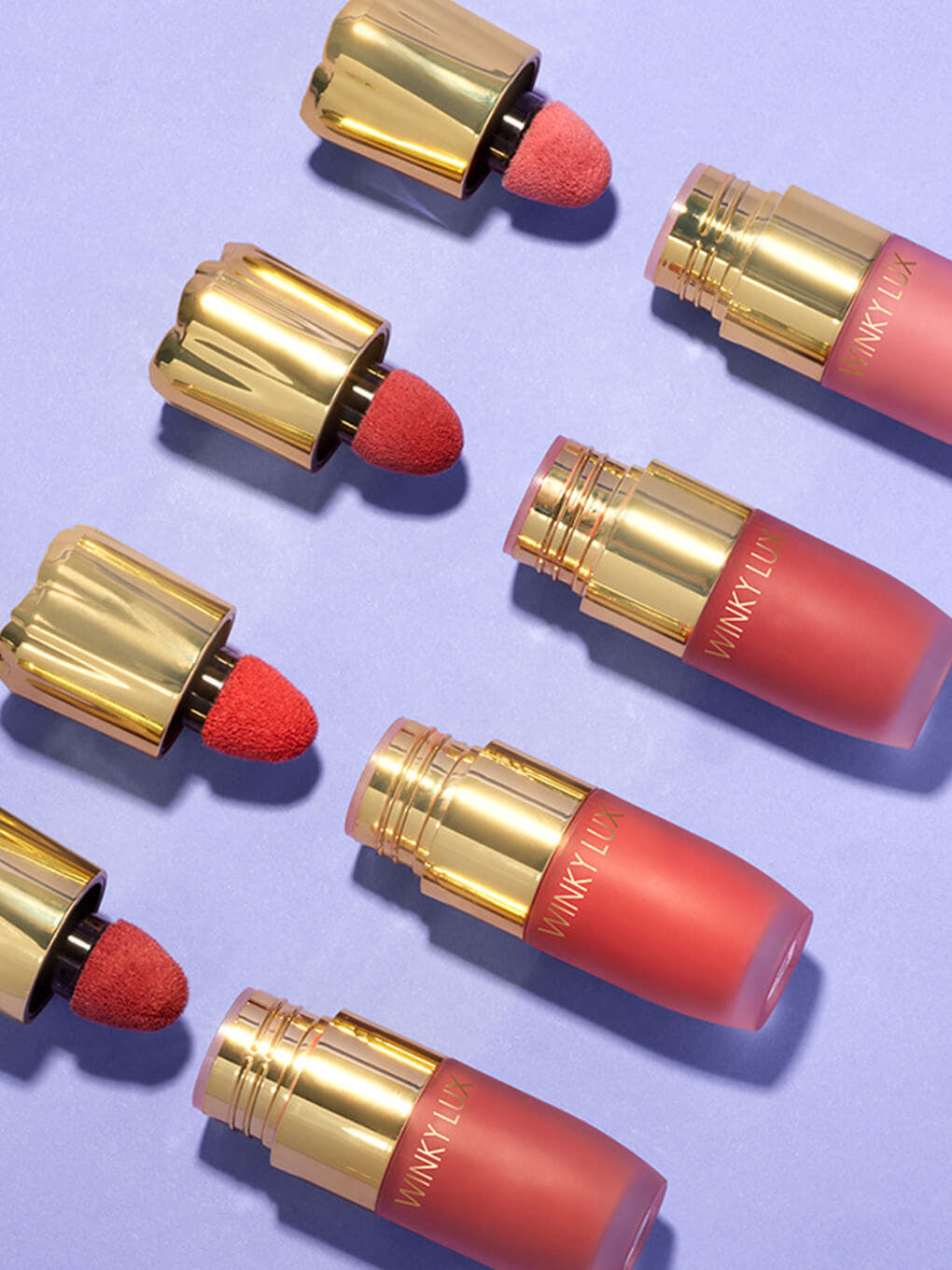 Queen -- 4 shades of cheeky rose liquid blush caps off lined up flat lay