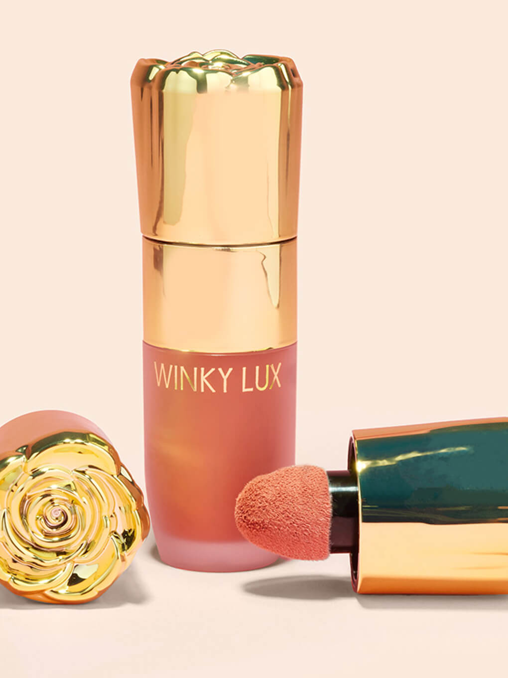 Queen -- cheeky rose liquid blush with caps laying next to