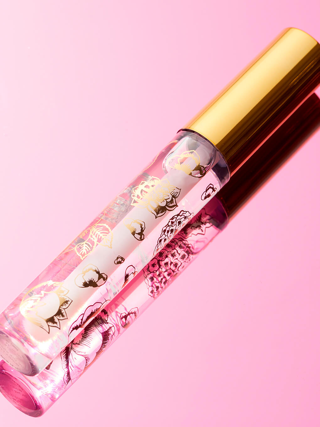 On The Rocks -- glossy boss lip gloss flat lay on pink background