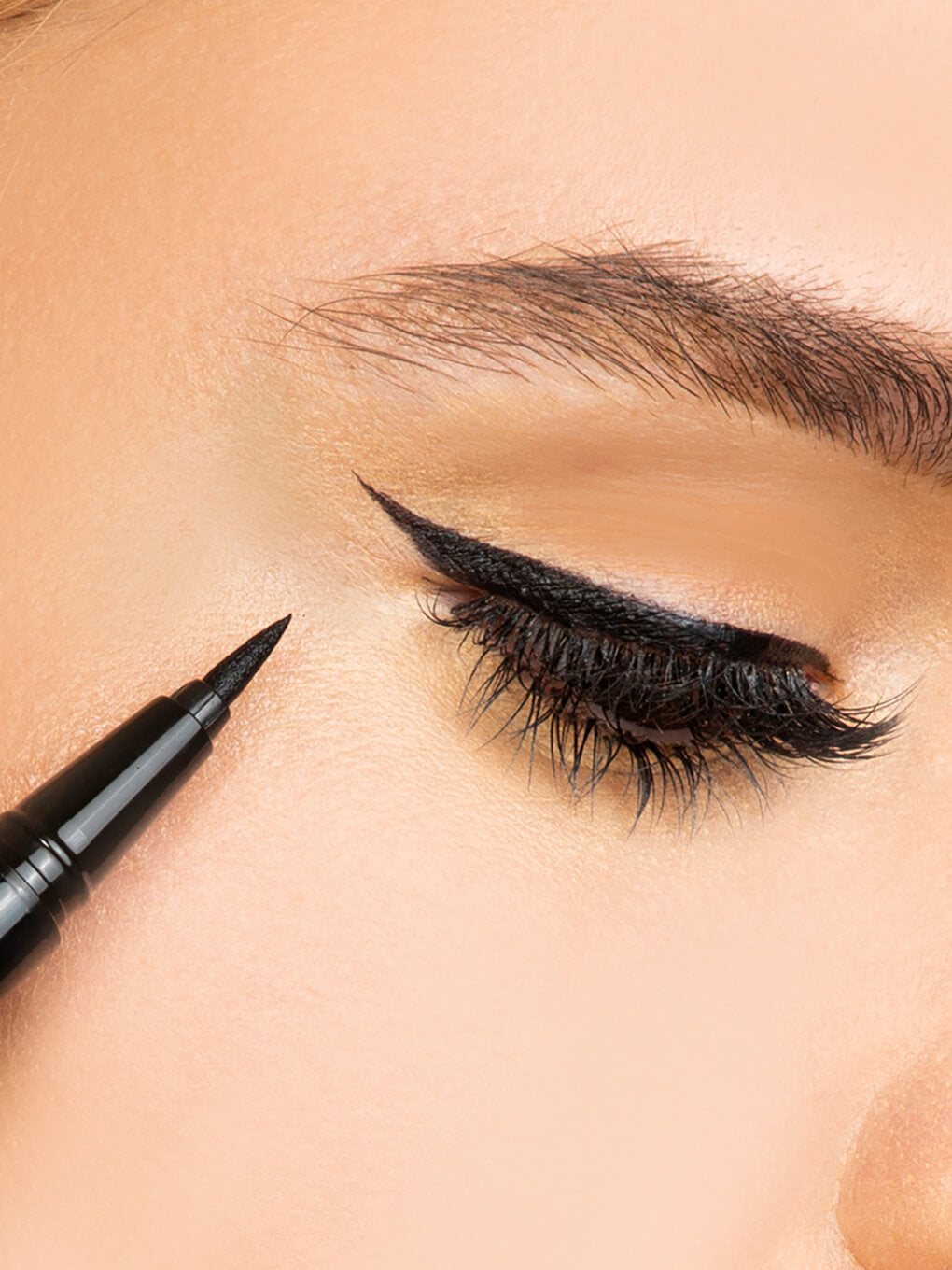 close up of brunette model wearing meowza liquid eyeliner