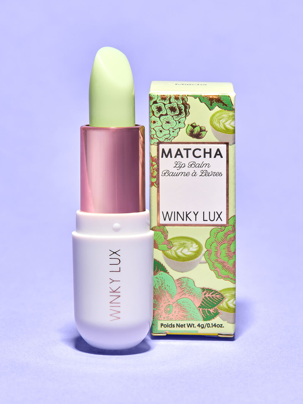 clear -- matcha lip balm and box standing up on purple backgrround