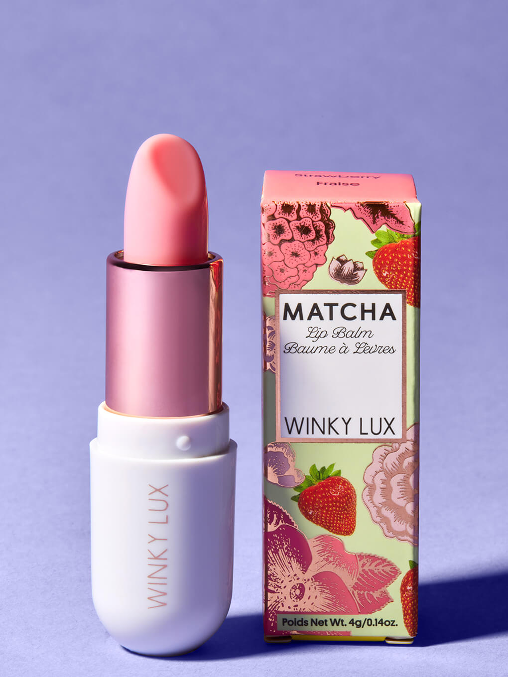 strawberry -- matcha lip balm and box standing up on purple backgrround