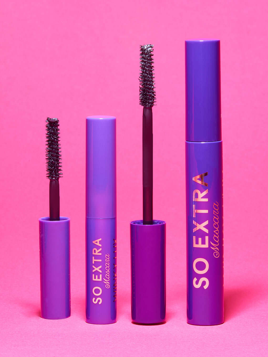 so extra volumizing mascara mini standing next to full size on pink background