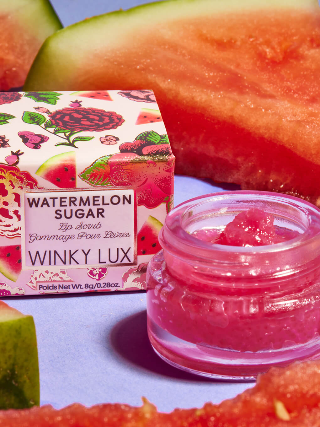 watermelon sugar lip scrub sitting next to box surrounded by watermelon slices