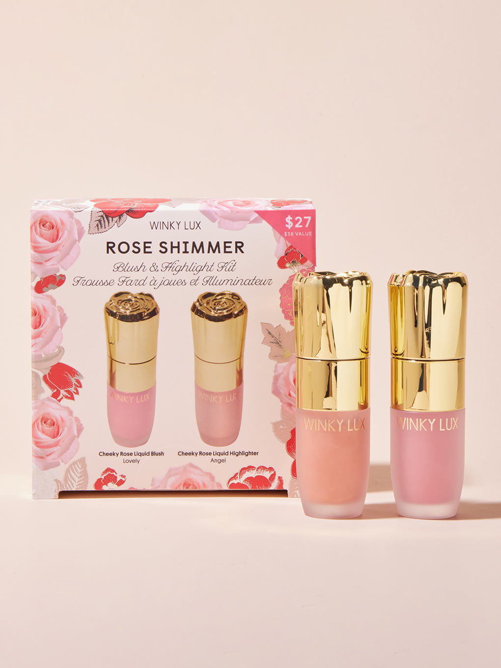 rose shimmer holiday gift set box with products standing next to on beige background