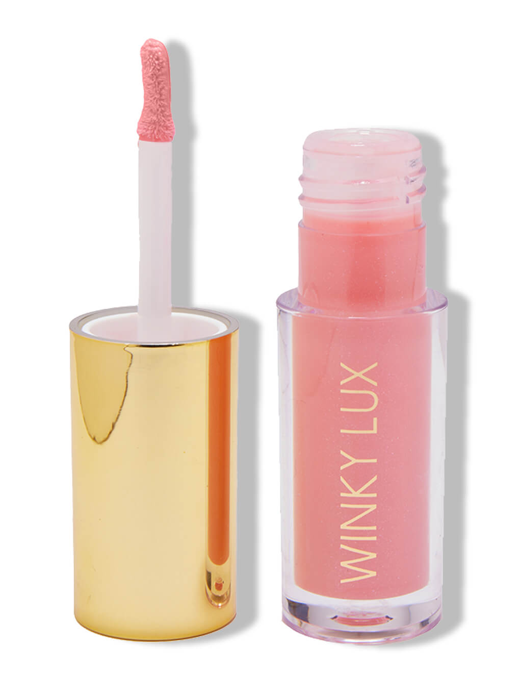 Passion -- tinted lip oil in sheer pink on white background next to cap