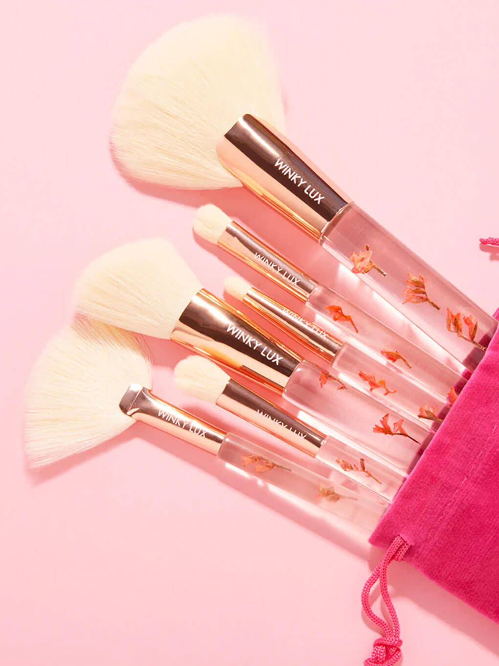 forever flower makeup brush 6 piece set coming out of pink bag on pink background