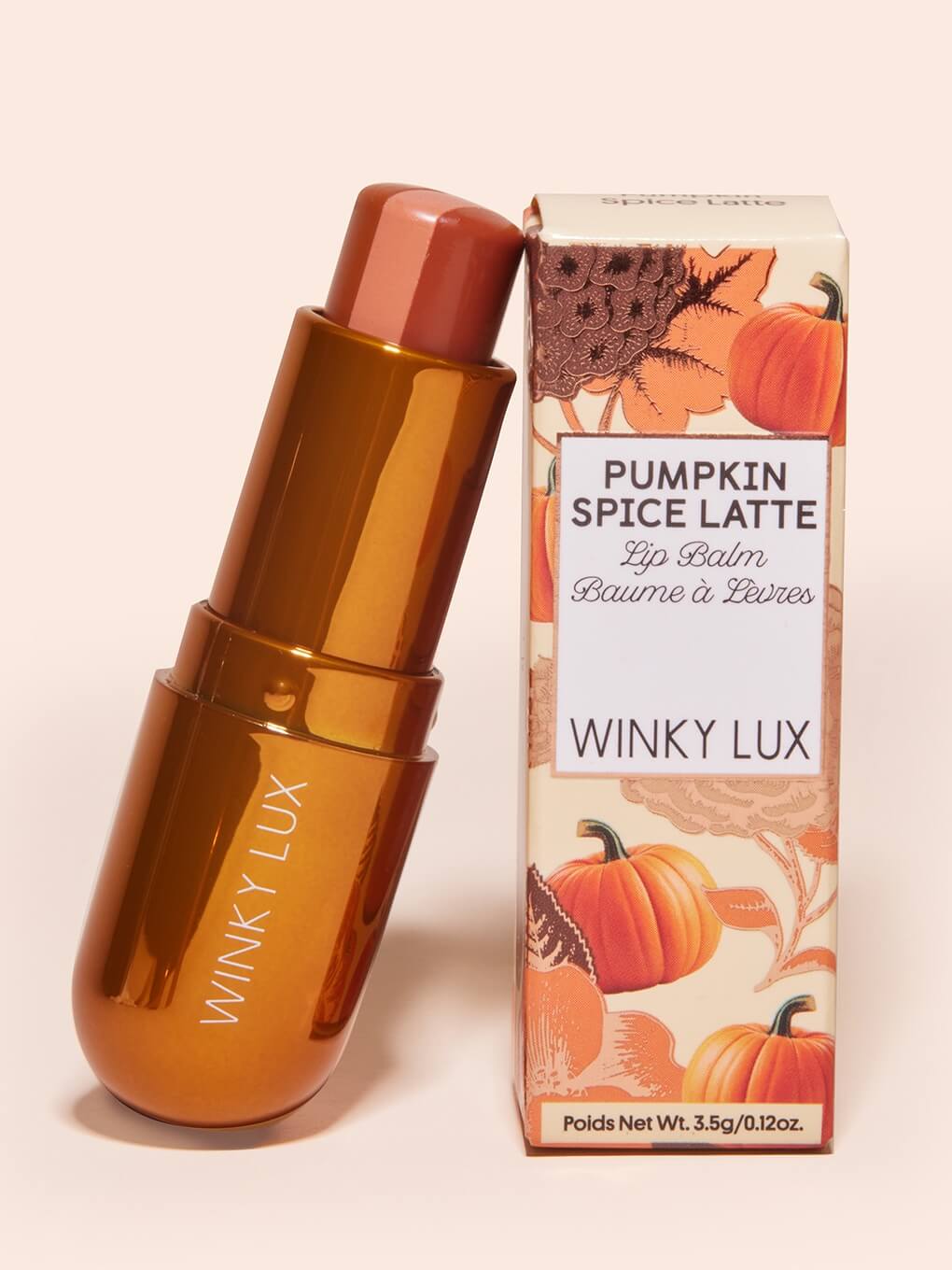 pumpkin spice latte lip balm without cap resting against box