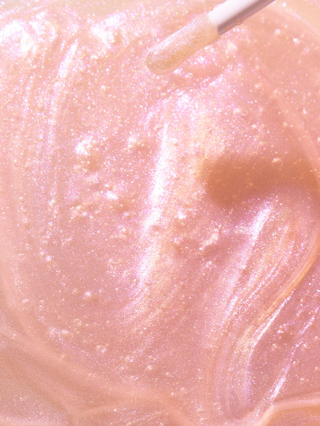 birthday cake shimmer -- full frame shot of pink lip oil goop with sparkle