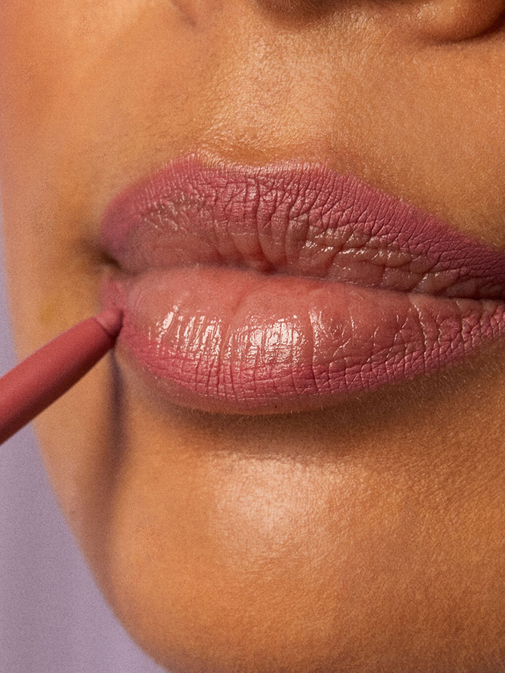 pippy -- close up of brunette model applying waterproof lip liner