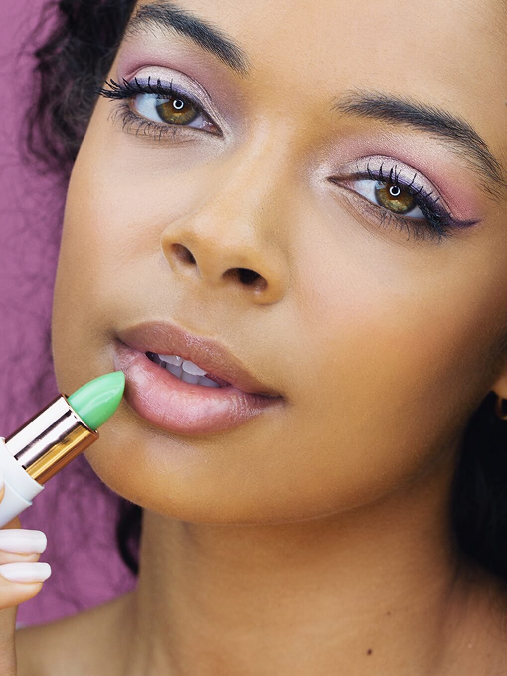 clear -- close up of model applying matcha lip balm