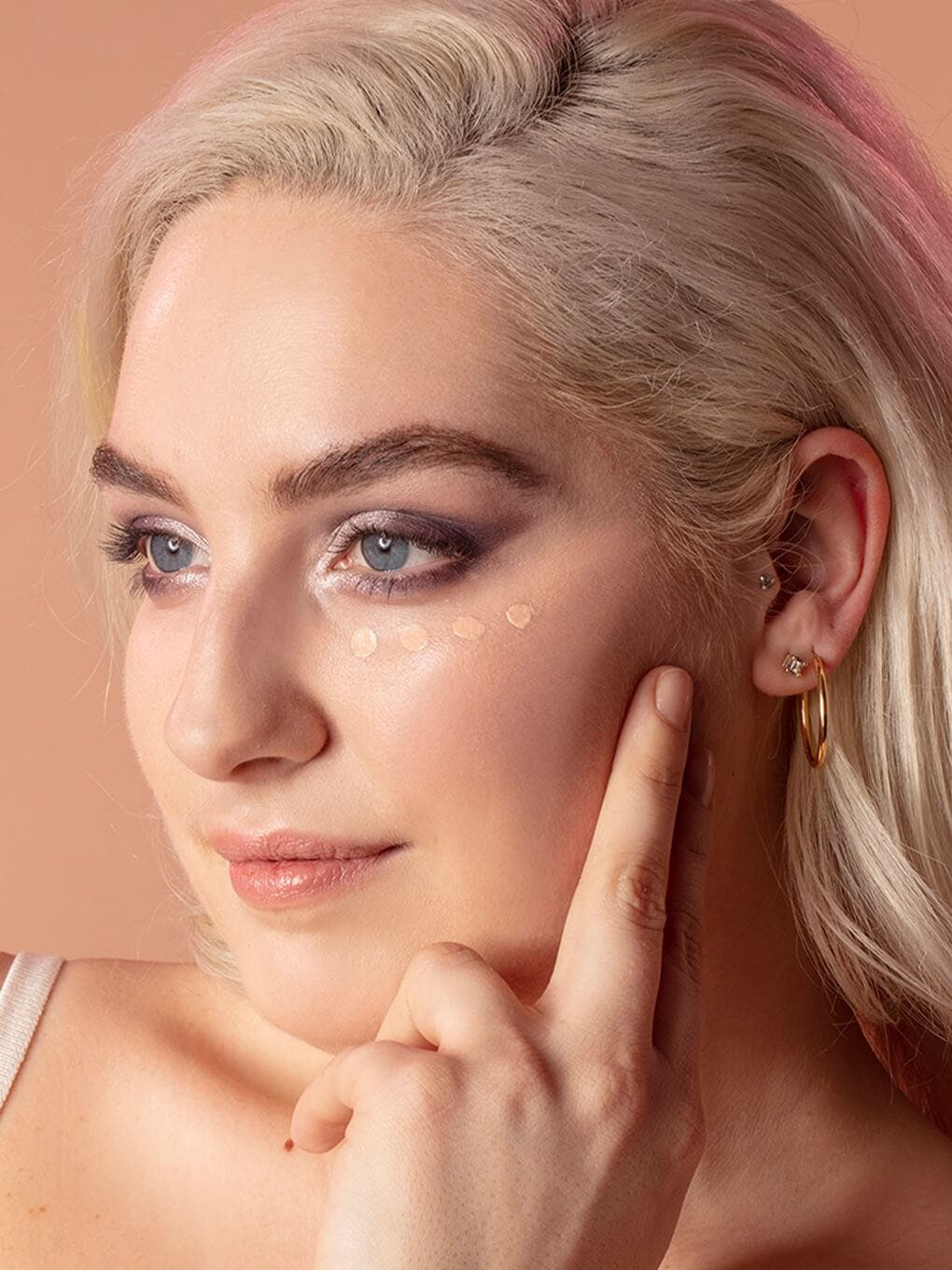 Fair -- close up of peeper perfect under eye concealer swatch on model