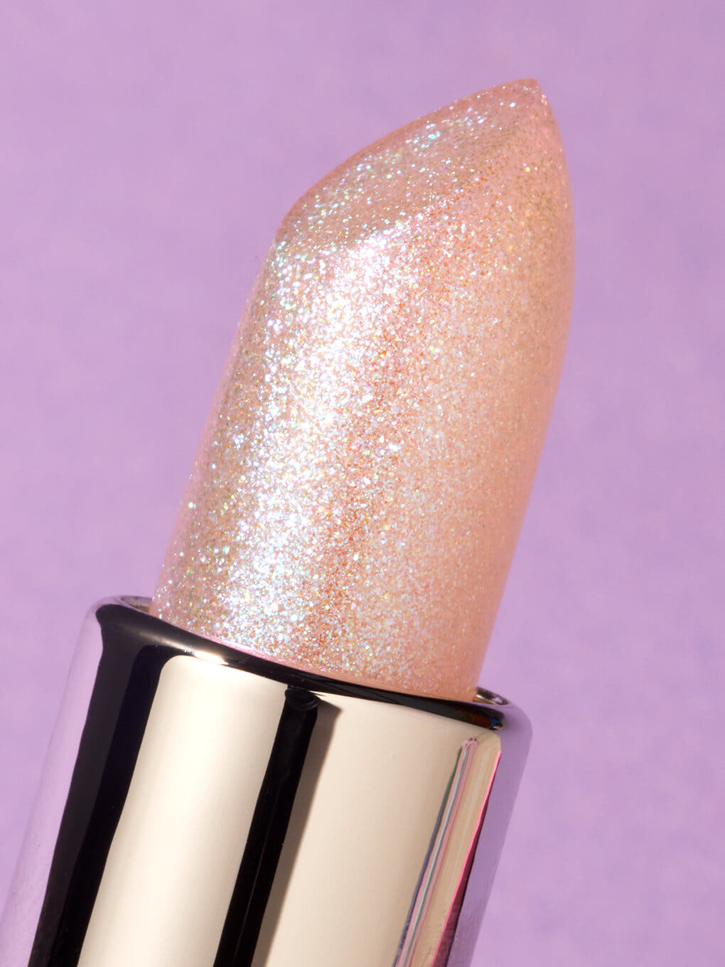 unicorn glimmer -- close up of glimmer ph balm no cap on purple background