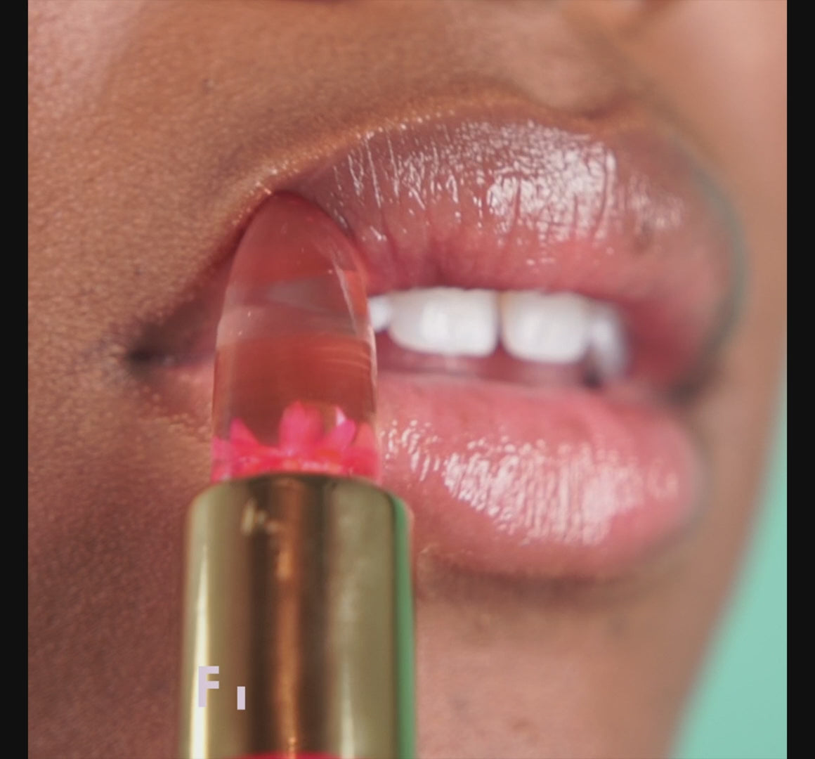 Pink -- video of close up application of ph lip balm to model's lips